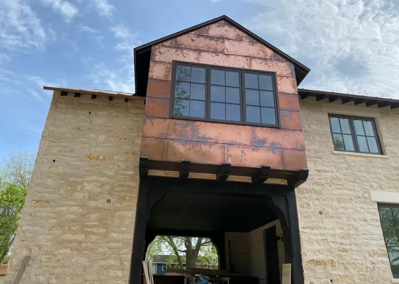 Copper metal panel facade on a stone building for Skylight Installation in Franklin